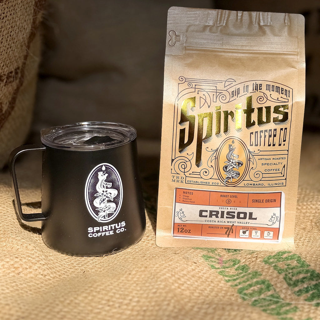 MiiR camp coffee cup beside a bag of Spiritus coffee on a burlap sack