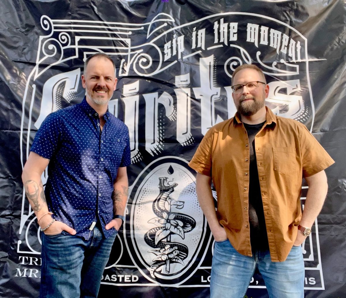 Nick and Jason of Spiritus Coffee in front of the Spiritus banner